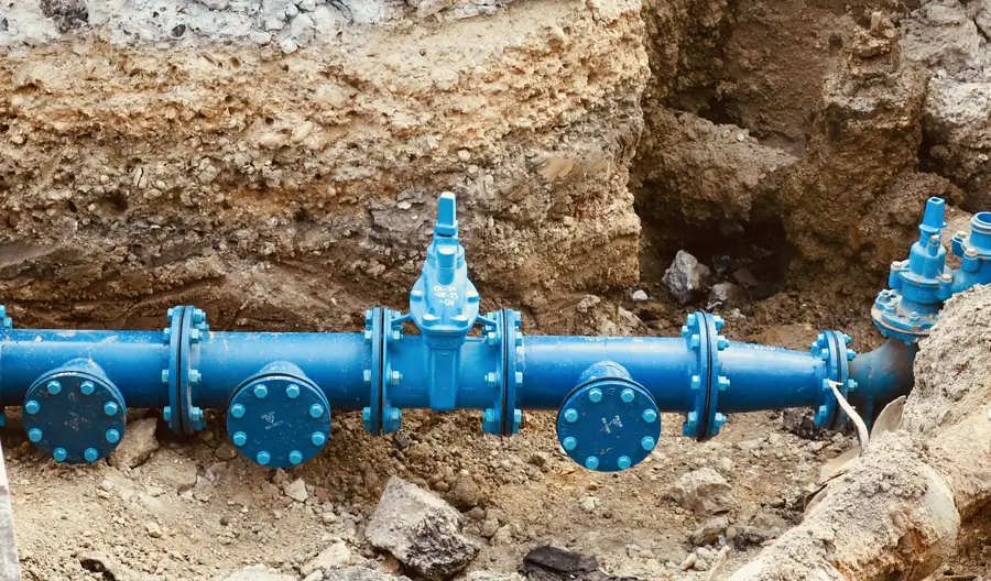 Blue drainage pipe laid in an excavated trench