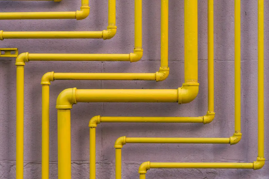 Yellow gas pipework installed along a wall