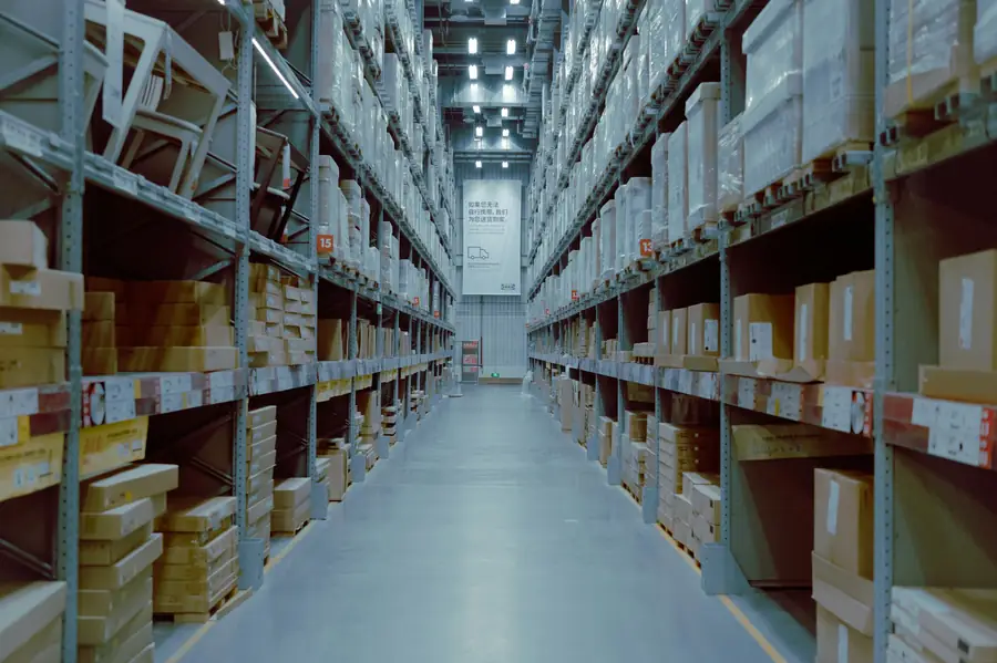 Warehouse aisle with shelving stocked with boxed supplies